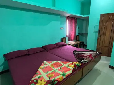 a bedroom with a purple bed in a room at The Retreat in Vālpārai