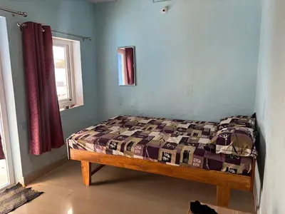 a bedroom with a bed in a room with a window at The Retreat in Vālpārai