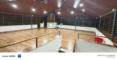 a large empty arena with a large wooden floor at Pranavam homestay in Guruvāyūr