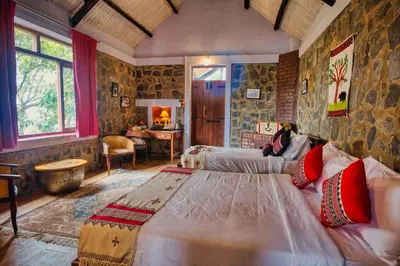 a bedroom with a large bed in a room at Hullathy by Red Earth in Ooty
