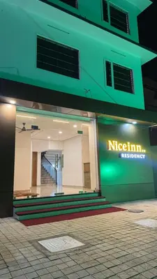 a building with a sign on the side of it at Nice Inn Residency in Kozhikode
