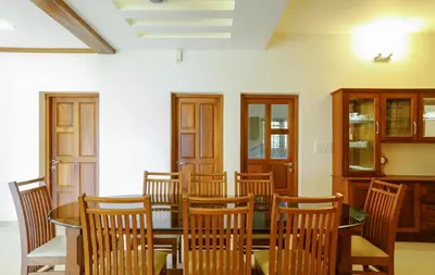 a dining room with a table and chairs at River Whisper Homestay in Cochin
