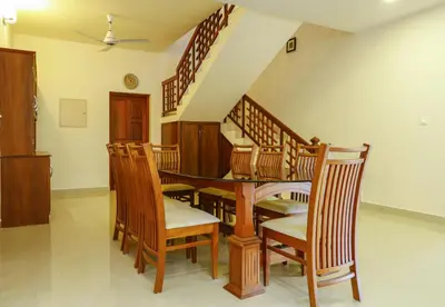 a dining room with a table and chairs at River Whisper Homestay in Cochin