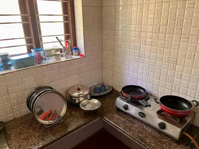 a kitchen counter with pots and pans on a stove at Bean & Breeze in Suntikoppa