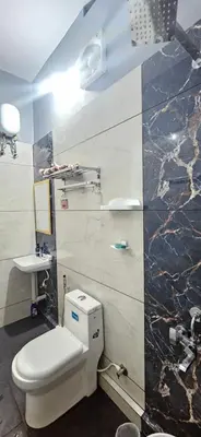 a bathroom with a toilet and a sink at Love Nest Inn Homestay in Agali