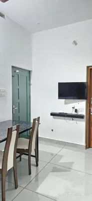 a dining room with a table and chairs at Love Nest Inn Homestay in Agali
