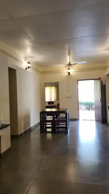 an empty room with a table and chairs in it at The Bear's Lair 2BHK Chembra Peak View in Vythiri