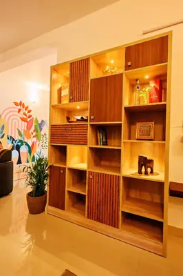 a large wooden book shelf in a living room at Antara Luxury Homestay in Alwaye