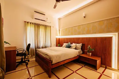 a hotel room with a bed and a fireplace at Antara Luxury Homestay in Alwaye