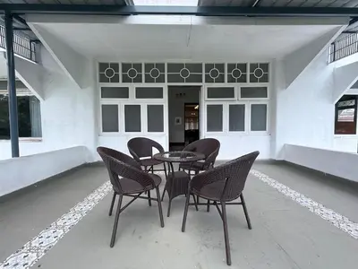 a patio with a table and chairs in a building at Himalaya - 6bh Bunglow in Mysore