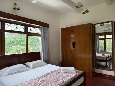 a bedroom with a bed and a large window at Himalaya - 6bh Bunglow in Mysore