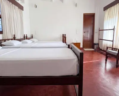 a bedroom with three beds with white sheets at Himalaya - 6bh Bunglow in Mysore