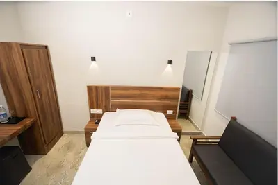 a bedroom with a bed and a wooden headboard at Kanak Residency in Green Island