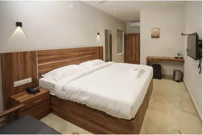 a bedroom with a large white bed in it at Kanak Residency in Green Island