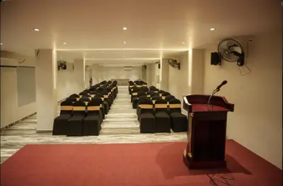 a room with chairs and a podium in a room at Kanak Residency in Green Island