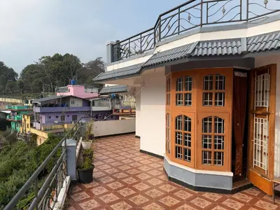 a balcony of a house with a view of a city at DM&sons in Coonoor