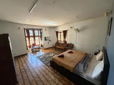 a bedroom with a bed and a couch in it at DM&sons in Coonoor