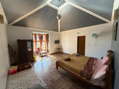 a bedroom with a large bed in a room at DM&sons in Coonoor