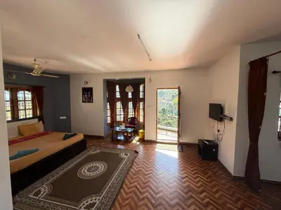 a bedroom with a bed and a rug on the floor at DM&sons in Coonoor