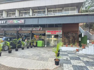 a store front with potted plants in front of it at Dream wagon hotel lakkidi in Vythiri
