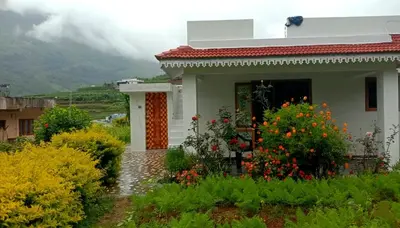 a small house with flowers in front of it at Kalpanahomestay in Vattavada