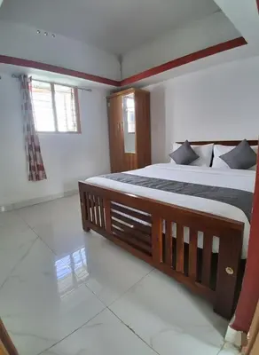 a bedroom with two beds and a window at Kalpanahomestay in Vattavada