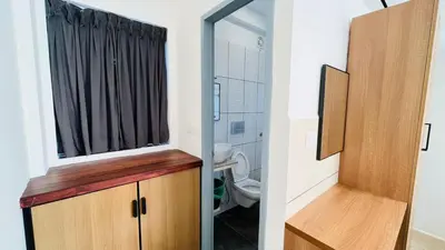 a bathroom with a toilet and a mirror at Jo Homes in Alwaye