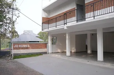 a no homes sign in front of a building at Jo Homes in Alwaye