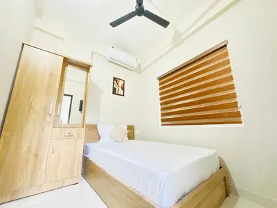 a bedroom with a bed and a window at Nila Inn Calicut Near Hilite Mall in Kozhikode
