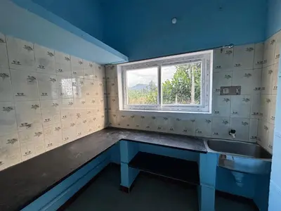 a bathroom with a sink and a window at Park view homestays in Vālpārai