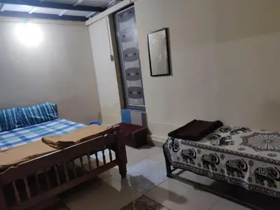 a bedroom with two beds in a room at Danny's Homestay Coorg in Madikeri