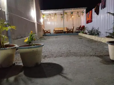 a patio with potted plants and a table and chairs at Hotel ZB comforts MYSORE in Mysore