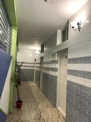 a hallway with striped walls and a plant in a building at Hotel ZB comforts MYSORE in Mysore