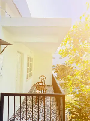 a chair sitting on the balcony of a house at Moonveil Luxury Villa Munnar in Munnar