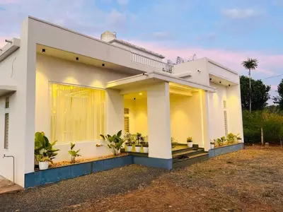 a white house with plants in front of it at Mistora Stays 2BHK Private villa in Kalpetta