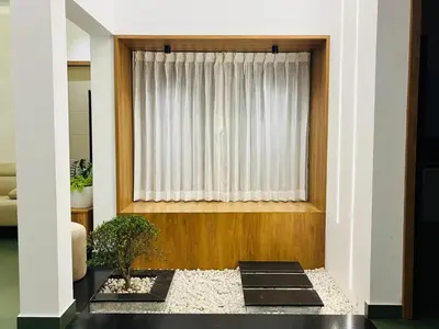a living room with a window and some plants at Mistora Stays 2BHK Private villa in Kalpetta
