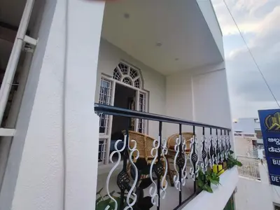 a balcony with a view of a building at Āsare attic in Mysore