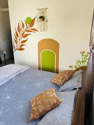 a bedroom with a bed with two pillows on it at Āsare attic in Mysore