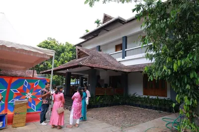 a group of people standing outside of a house at Heritage Home in Ernakulam North Paravur in Ernakulam