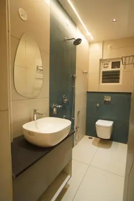 a bathroom with a sink and a toilet at The Grand Sarayu in Mysore