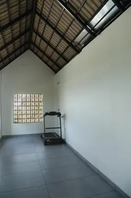 an empty room with a window and a treadmill at Brand new 4 BHK luxury villa near kochi airport in Nedumbassery