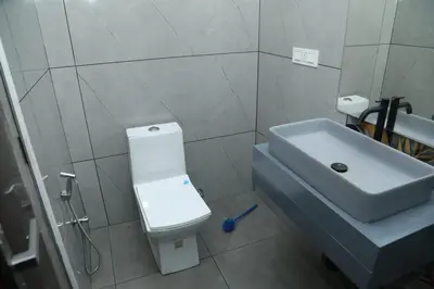 a bathroom with a white toilet and a sink at Brand new 4 BHK luxury villa near kochi airport in Nedumbassery