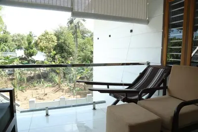 a room with a table and chairs and a large window at Brand new 4 BHK luxury villa near kochi airport in Nedumbassery