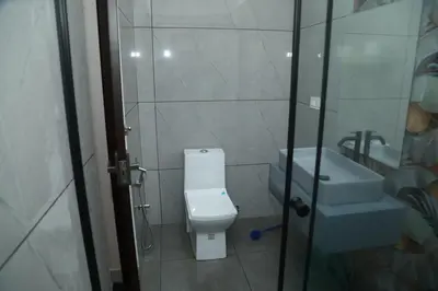 a bathroom with a toilet and a sink at Brand new 4 BHK luxury villa near kochi airport in Nedumbassery
