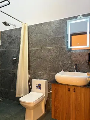 a bathroom with a toilet and a sink at Sunset Villa Dusk looks better from here in Mysore