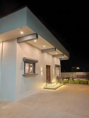 a white building with a window on the side of it at Sunset Villa Dusk looks better from here in Mysore