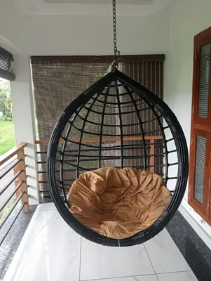 a hanging bed in a cage in a room at Izzath Villa in Kottakkal