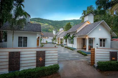 a house with a driveway in front of it at New Abrigo Resorts in Perintalmanna
