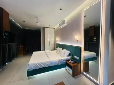 a bedroom with a large bed and a large mirror at Velora Hotel And Resorts in Devāla
