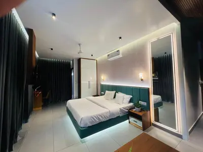 a bedroom with a large bed and a large mirror at Velora Hotel And Resorts in Devāla